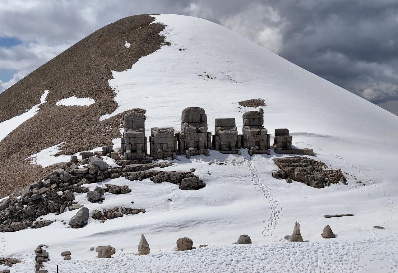 Snow-covered statues are seen at the Nemrut Mountain archaeological site in Adiyaman, Türkiye, April 7, 2026. (AA Photo)