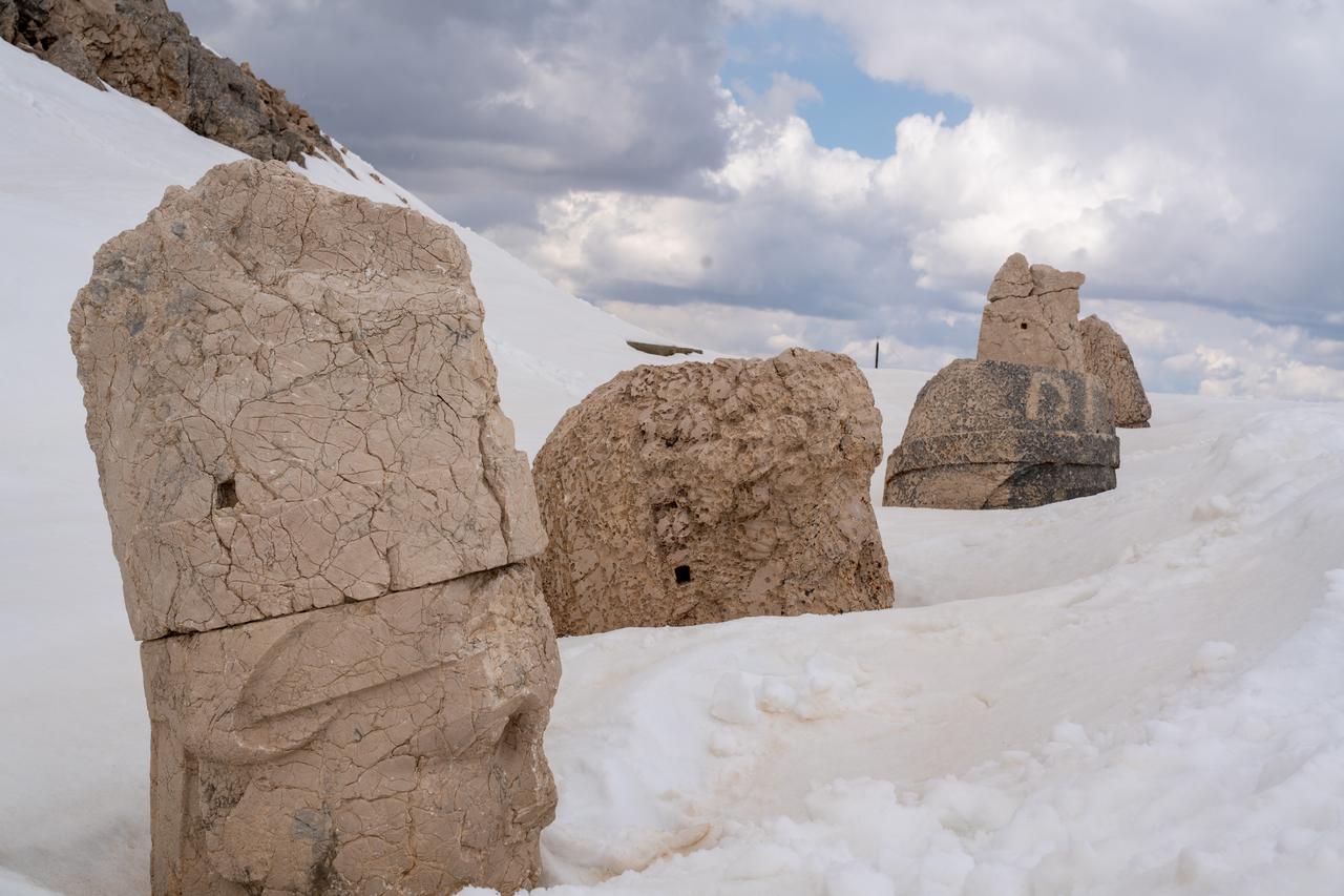 Snow-covered stone heads are seen at the Nemrut Mountain archaeological site in Adiyaman, Türkiye, April 7, 2026. (AA Photo)