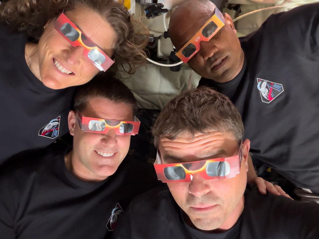 Artemis II's Mission Specialist Christina Koch (top L), Mission Specialist Jeremy Hansen (bottom L), Commander Reid Wiseman (bottom R), and Pilot Victor Glover (top R) wearing eclipse viewers during their lunar flyby, on April 6, 2026. (AFP Photo)