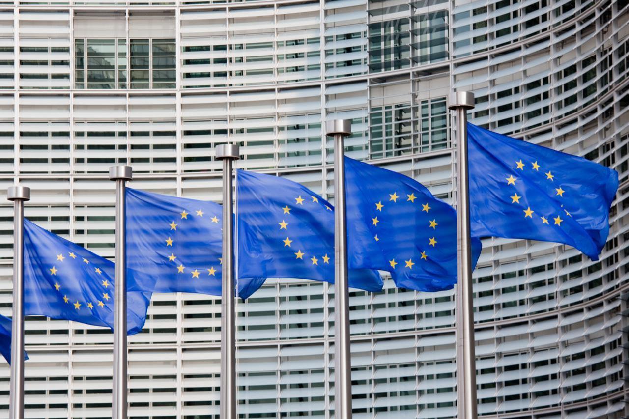 A line of EU flags stands in front of the European Commission building in Brussels. (Adobe Stock Photo)