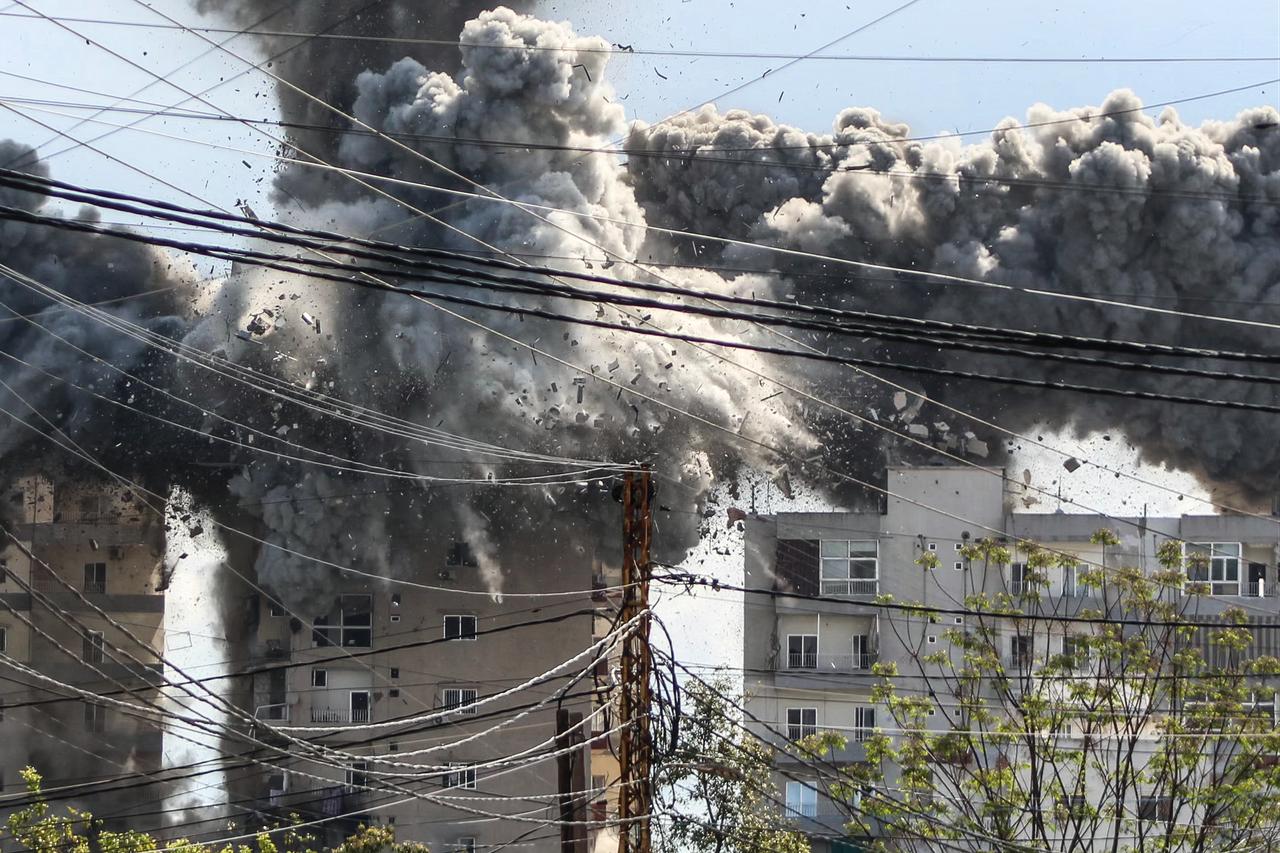 Smoke and debris rise after a building is hit by an Israeli airstrike in the area of Abbasiyeh, on the outskirts of the southern Lebanese city of Tyre, on April 8, 2026. (AFP Photo)
