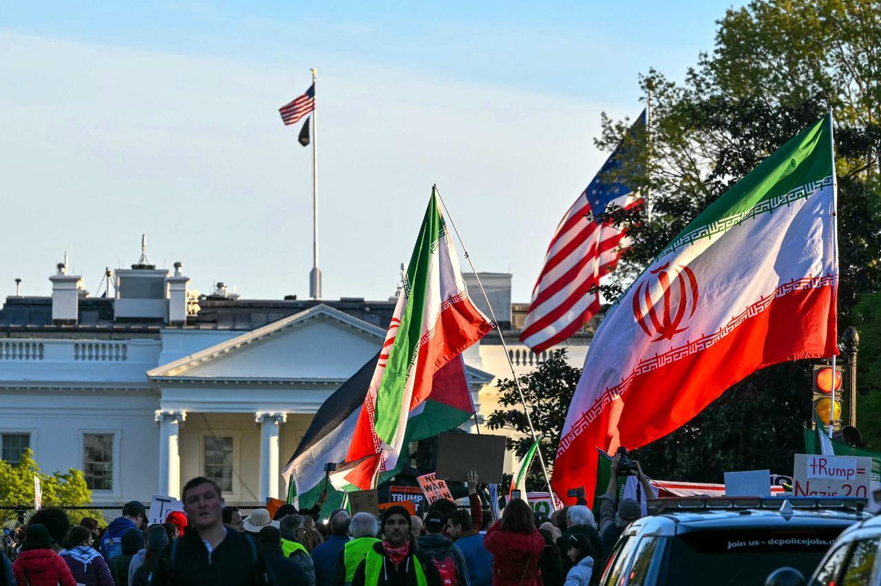 Demonstrators wave Iranian flags during a protest against US military action in Iran near the White House in Washington, DC, on April 7, 2026. (AFP Photo)