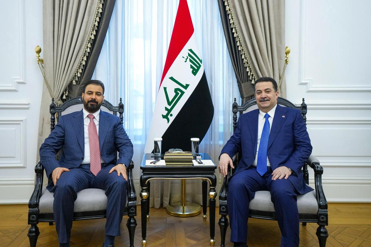 This handout photograph taken and released on April 28, 2026 shows outgoing Iraqi PM Mohammed Shia al-Sudani (R) meeting new prime minister-designate Ali al-Zaidi in Baghdad. (Photo by Iraqi Prime Minister's Press Office/AFP)