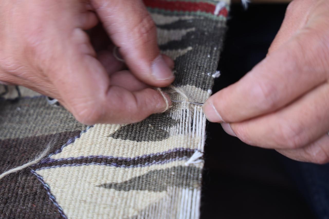 Ramazan Akgul meticulously works on carpets. Nevsehir, Türkiye, May, 2026. (IHA Photo)