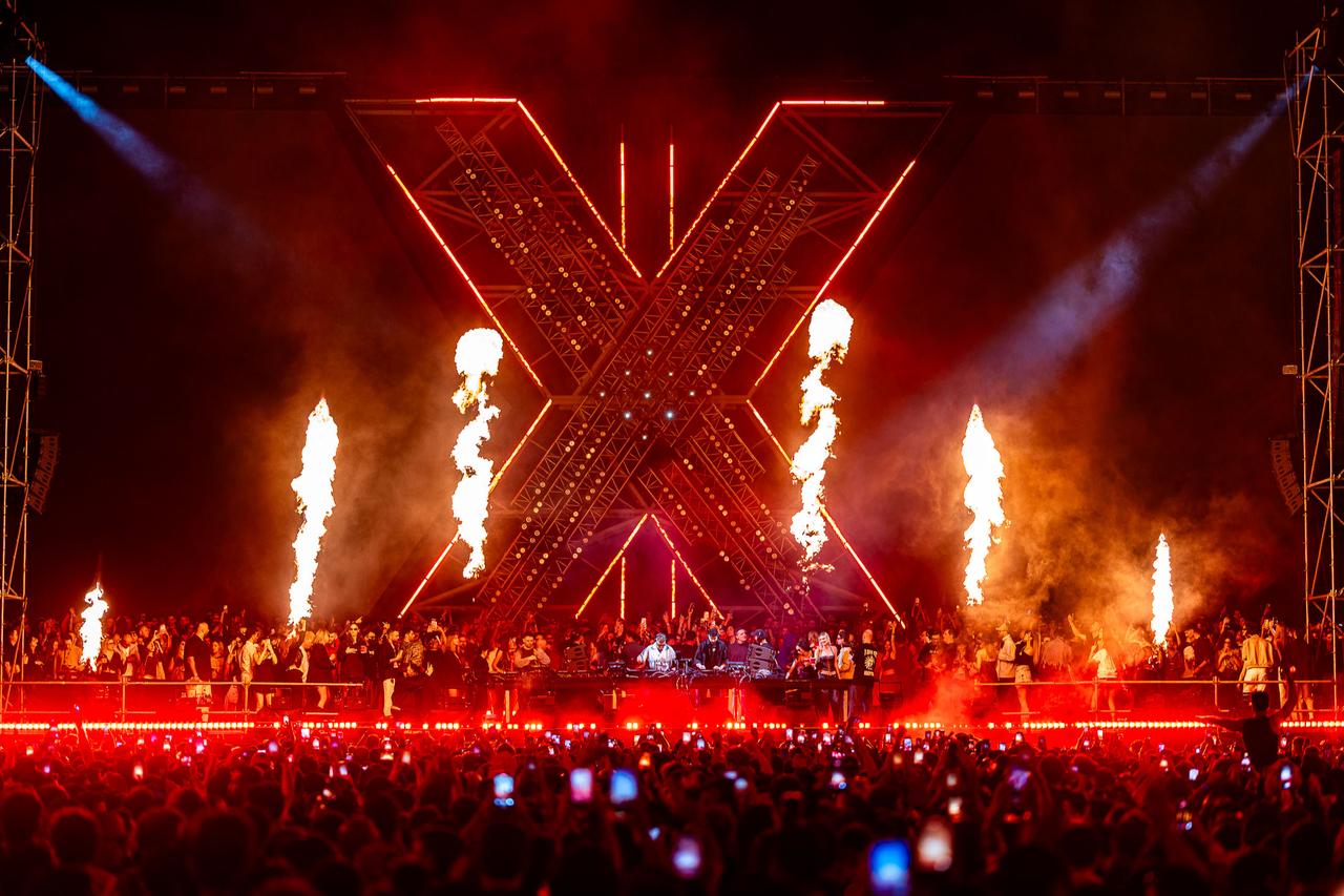 Pyrotechnics and red lighting frame Adriatique’s “X” stage as crowds gather for the open-air electronic music event in Istanbul on May 9, 2026. (Photo via TemaCC)