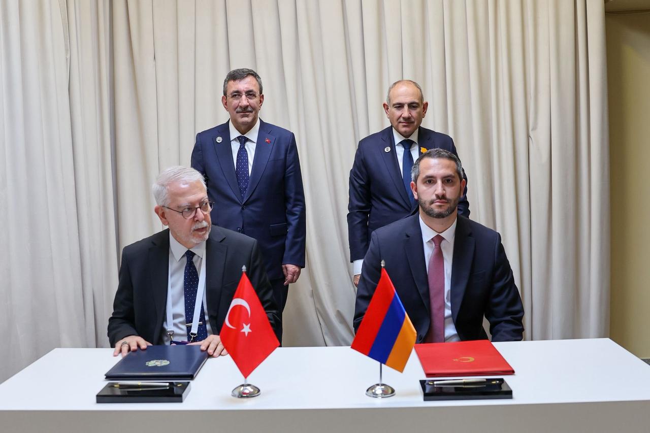 Turkish Special Envoy Serdar Kilic (seated left) and Armenian VP of National Assembly Ruben Rubinyan (seated right) sign the protocol for the joint restoration of the Ani Bridge in Yerevan, as Turkish Vice President Cevdet Yilmaz (standing left) and Armenian Prime Minister Nikol Pashinyan (standing right) look on May 4, 2026. (Photo via X/@_cevdetyilmaz)