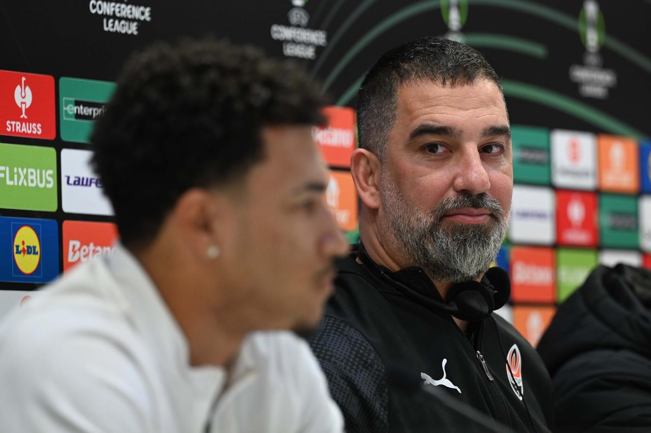 Shakhtar Donetsk head coach Arda Turan (R) and player Kaua Elias (L) speak during a press conference ahead of the UEFA Conference League semi-final second leg match against Crystal Palace at Selhurst Park in London, United Kingdom, May 6, 2026. (AA Photo)