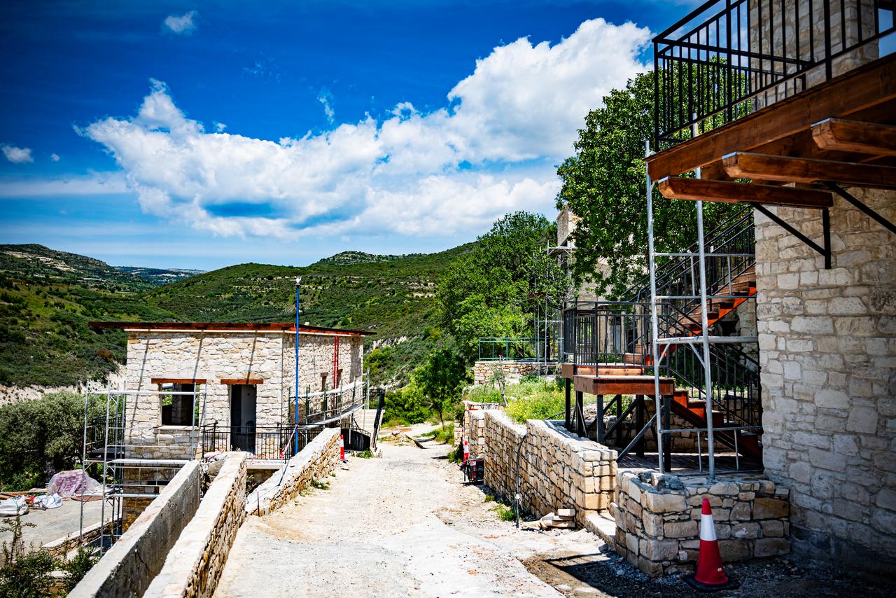 Renovated stone buildings and ongoing construction are seen in Trozena, Greek Cyprus. (Photo via Politis)