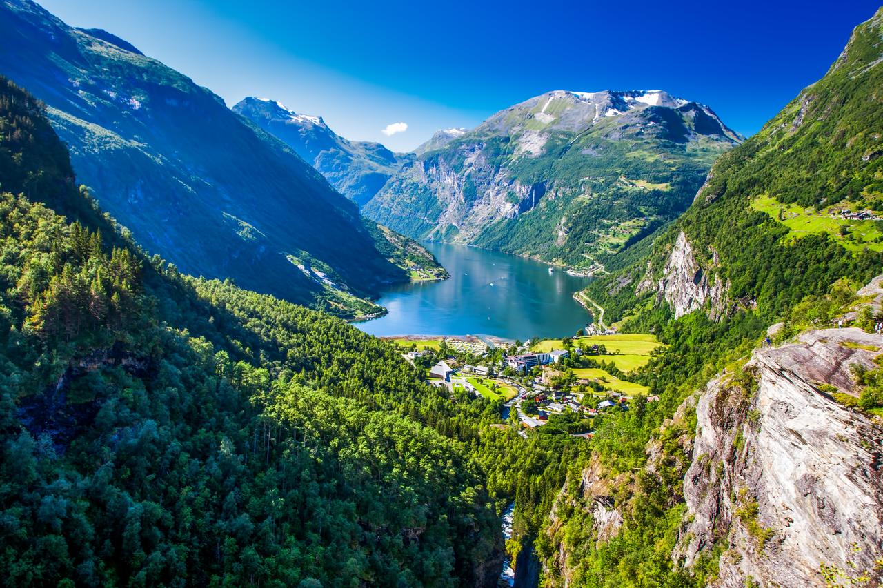 A panoramic view of the UNESCO-listed Geirangerfjord in western Norway, known for its steep mountains, deep blue waters and dramatic fjord landscape. (Adobe Stock Photo)