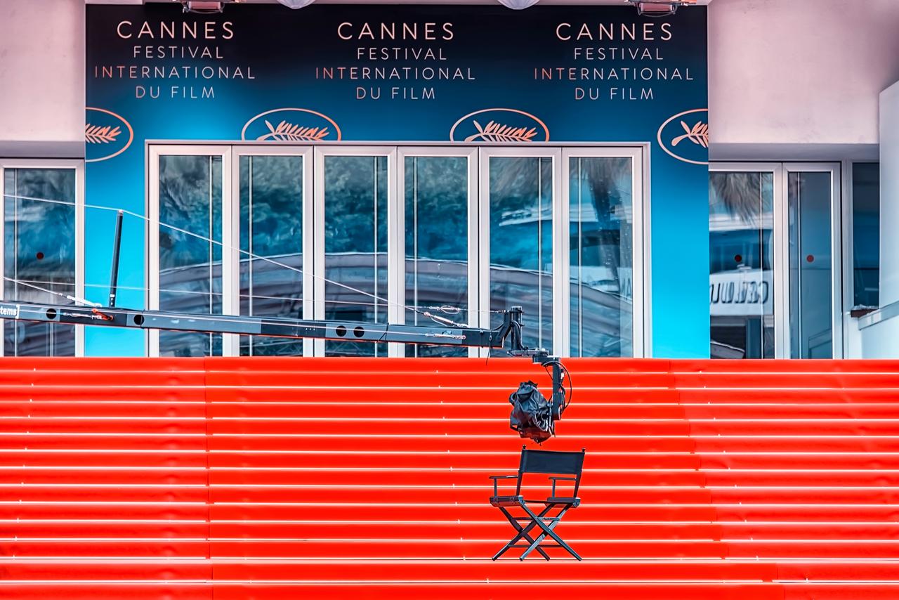 A camera crane and chair are seen on the red-carpet steps at the Cannes Film Festival venue in Cannes, France. (Adobe Stock Photo)