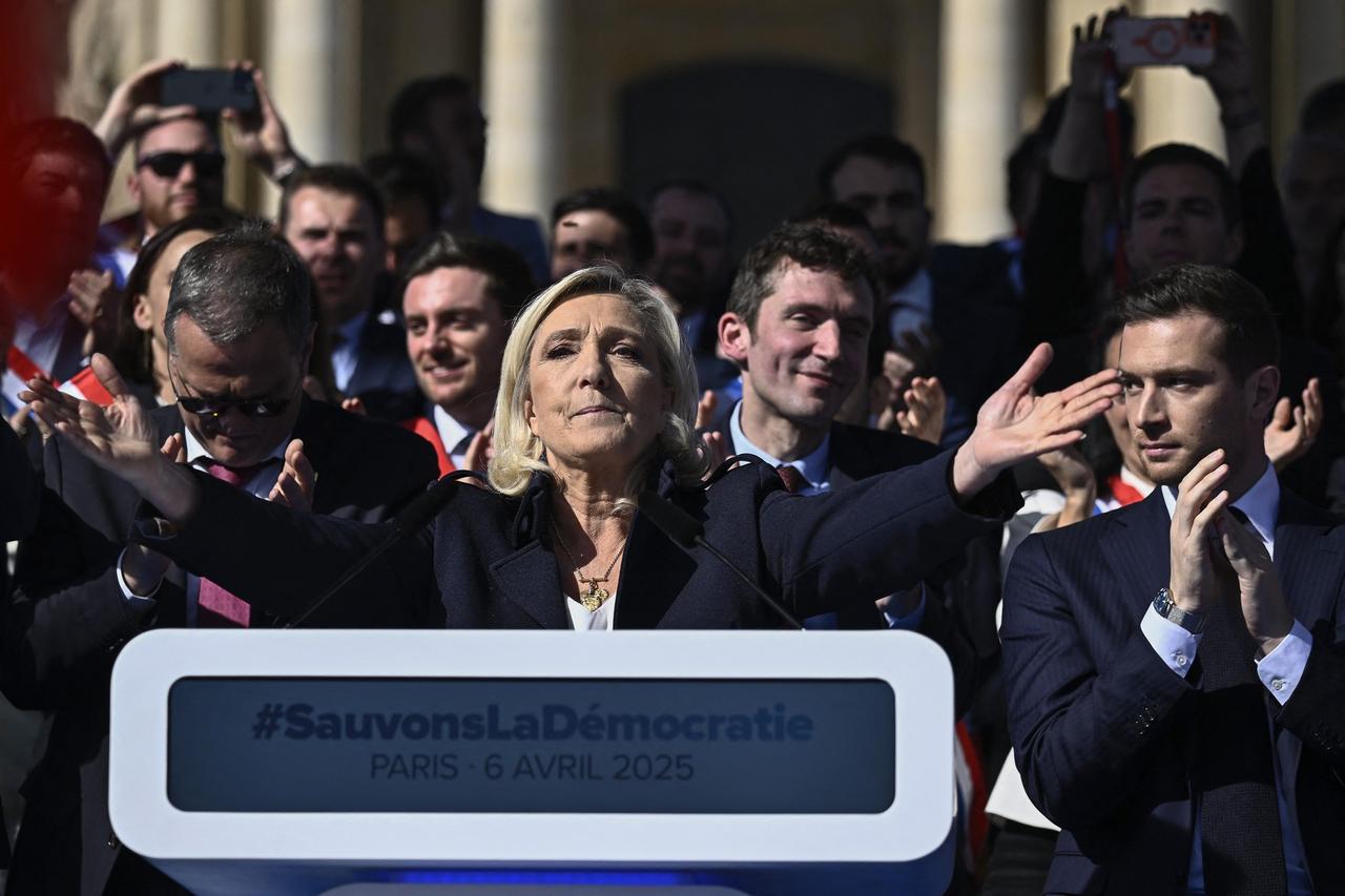RN party's President Jordan Bardella (R) applauds as President of Rassemblement National parliamentary group Marine Le Pen gestures after delivering a speech during a rally in her support, after she was convicted of a fake jobs scheme at the EU parliament, in Paris, France, April 6, 2025. (AFP Photo)