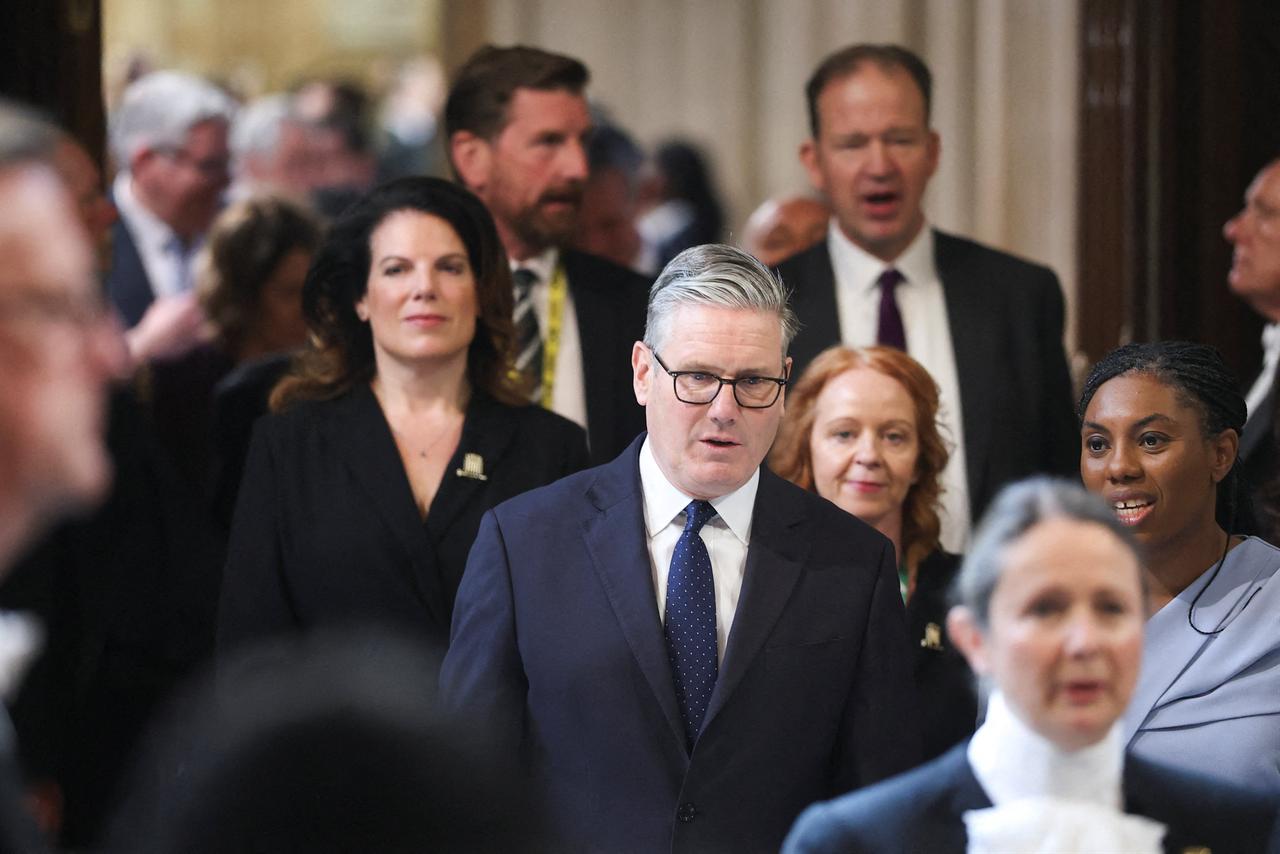Britain's Prime Minister Keir Starmer (C) walks through the House of Commons to attend the State Opening of Parliament at the Palace of Westminster in London on May 13, 2026. (AFP Photo)