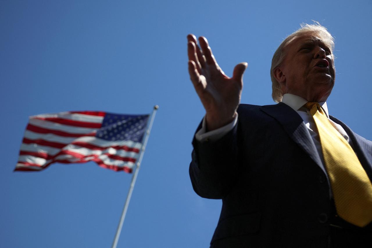 U.S. President Donald Trump speaks in front of the American flag to the press as he departs the White House on May 12, 2026 in Washington, DC. Trump is traveling to China where he is scheduled to meet with Chinese President Xi Jinping. (AFP Photo)