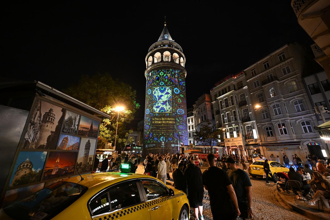 Galata Tower lights up with a cultural heritage-themed projection show in Istanbul to raise awareness about the protection and return of cultural artifacts, May 13, 2026. (AA Photo)