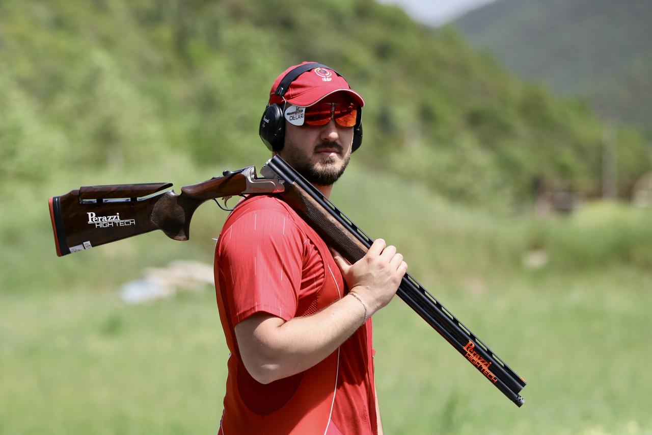 Turkish shooter Nedim Tolga Tuncer poses with his shotgun during the Trap World Cup in Kazakhstan, where he set a record and continued his push for an Olympic quota, on May 14, 2026. (AA Photo)