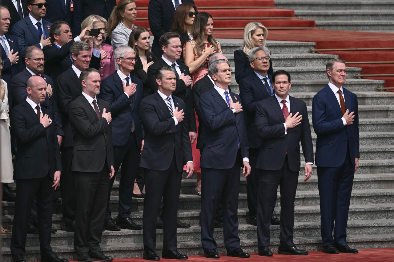 US Secretary of Defense Pete Hegseth (bottom centre L), US Treasury Secretary Scott Bessent (bottom centre R), Secretary of State Marco Rubio (bottom 2nd R), Nvidia founder and CEO Jensen Huang (second row R), senior advisor Stephen Miller (bottom L), Tesla and SpaceX CEO Elon Musk (C second row) and Apple CEO Tim Cook (centre L middle row) attend a welcome ceremony for US President Donald Trump at the Great Hall of the People in Beijing, May 14, 2026. (AFP Photo)