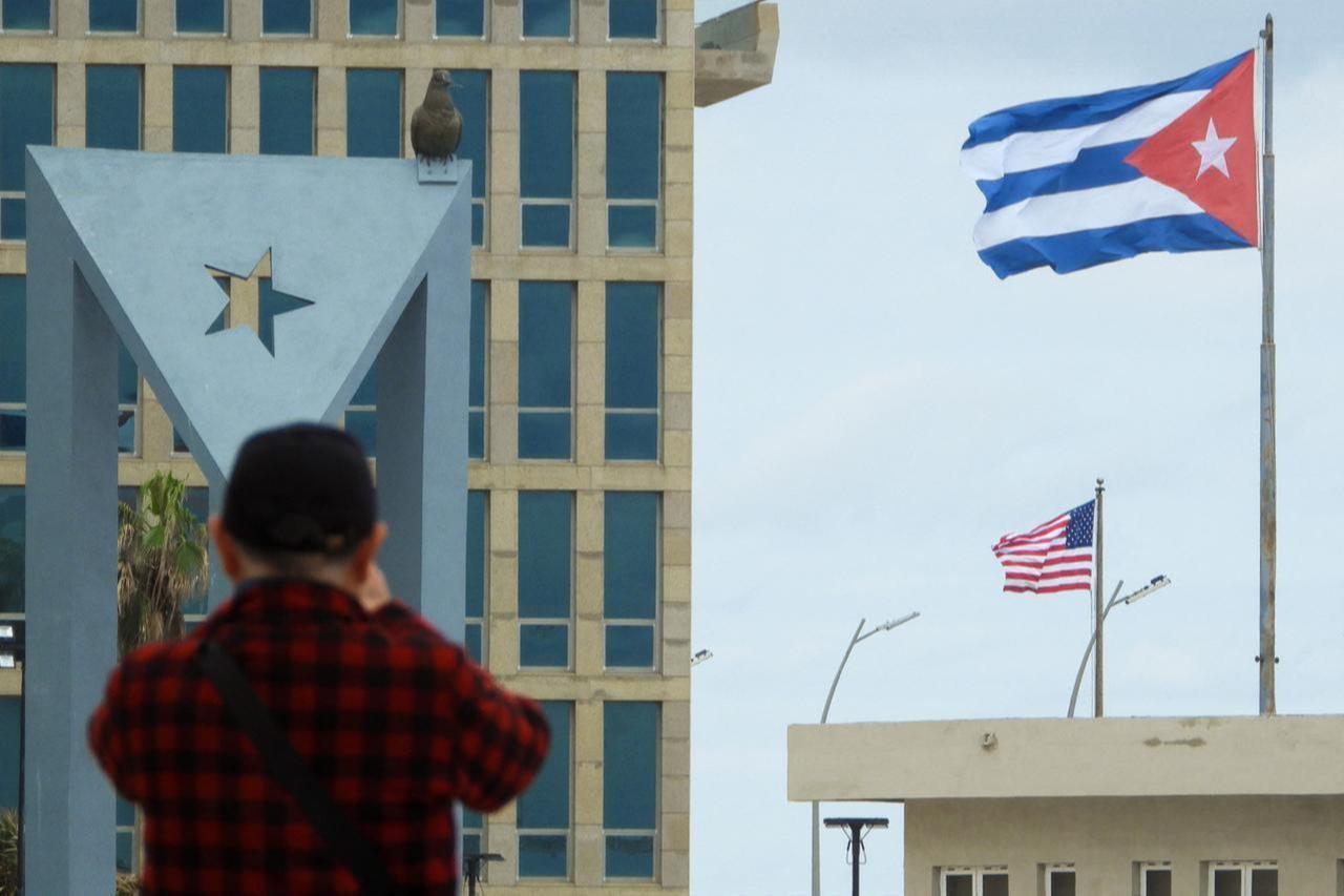 A tourist takes pictures of the US Embassy with the US flag and the Cuban flag in the background in Havana, January 30, 2026. (AFP Photo)