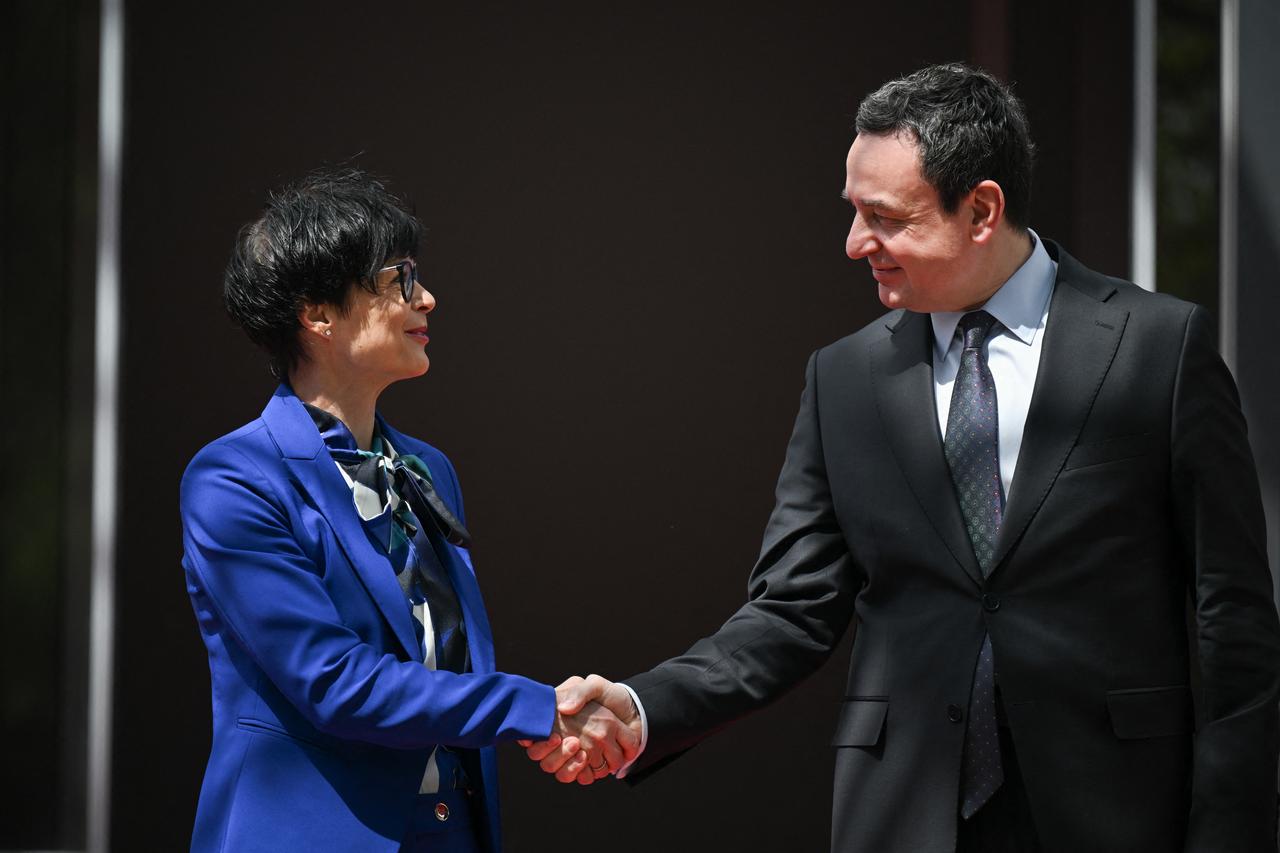 Kosovo's Prime Minister Albin Kurti greets EU Commissioner for Enlargement Marta Kos (L) in Pristina on May 15, 2026. (AFP Photo)