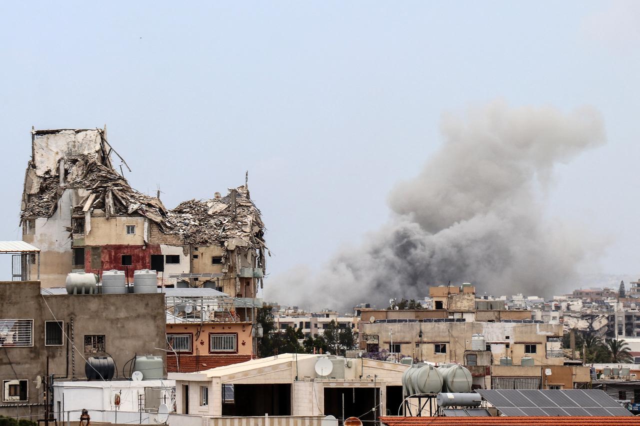 Smoke rises behind a damaged building following an Israeli airstrike in the southern city of Tyre, May 15, 2026. (AFP Photo)