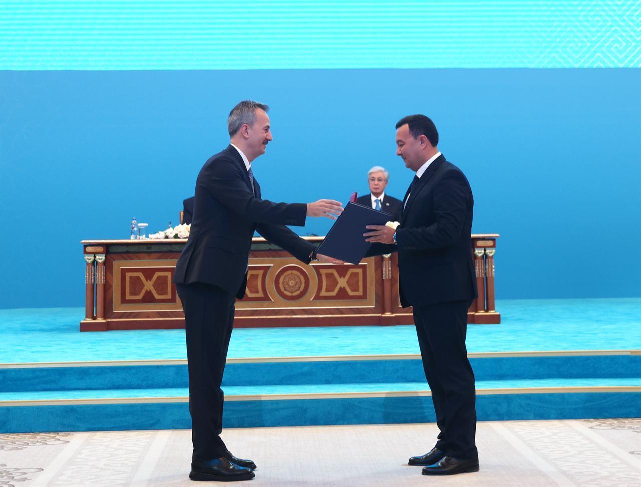 Secretariat of Defense Industries (SSB) President Haluk Gorgun (L) and Nurlan Kuzhayev, head of Kazakhstan's Aircraft Repair Plant No. 406 JSC, during the signing ceremony of bilateral agreements in Astana, Kazakhstan, May 14, 2026. (Photo via Turkish Presidency/HO)