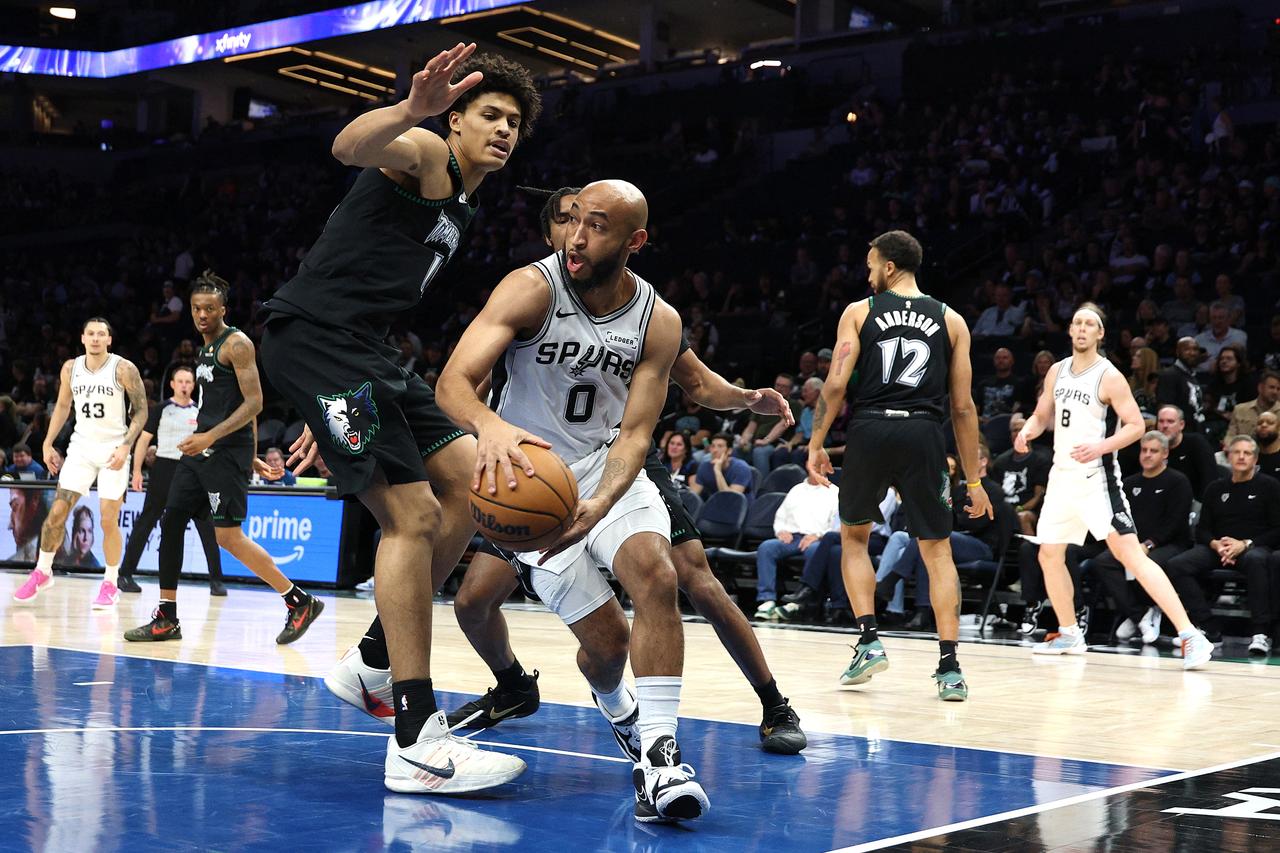 Jordan McLaughlin of the San Antonio Spurs passes the ball under pressure from Joan Beringer of the Minnesota Timberwolves during the fourth quarter of Game 6 in the Western Conference semifinals at Target Center in Minneapolis, May 15, 2026. (AFP Photo)