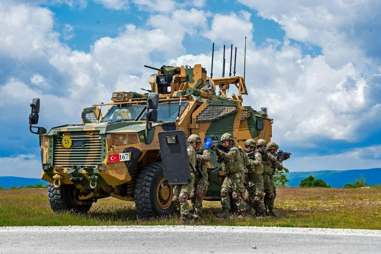 Personnel from the Turkish Armed Forces (TAF) use a Vuran armored vehicle for cover during urban operations training at the Borovac Training Area as part of NATO-Serbia Exercise 2026. (Photo via jfcnaples.nato)