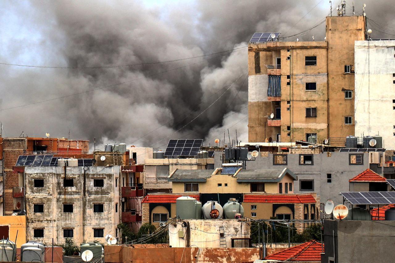 Smoke rises behind buildings following an Israeli airstrike in the southern city of Tyre on May 15, 2026. (AFP Photo)