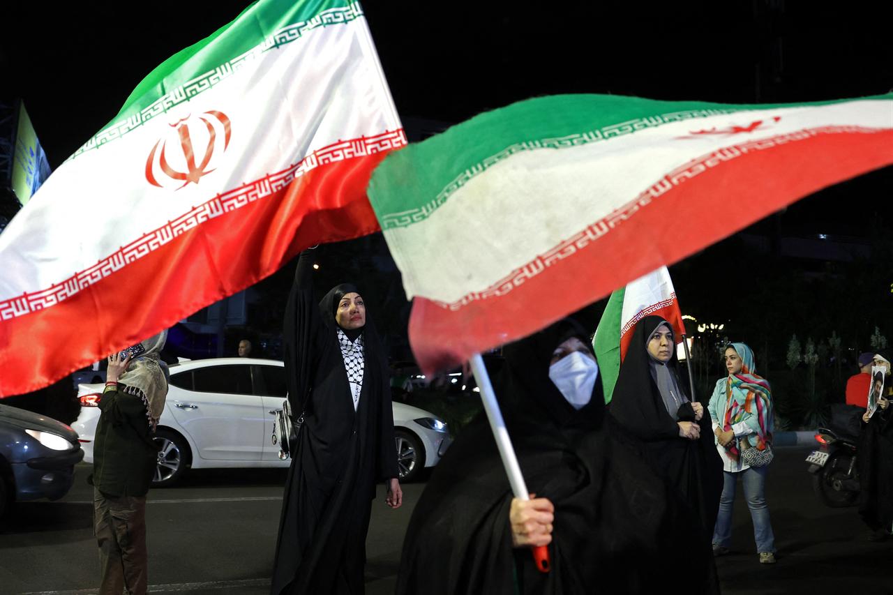 Women hold Iran's national flags during an anti-US and Israel protest at the Hafte Tir Square in Tehran, Iran, May 17, 2026. (AFP Photo)