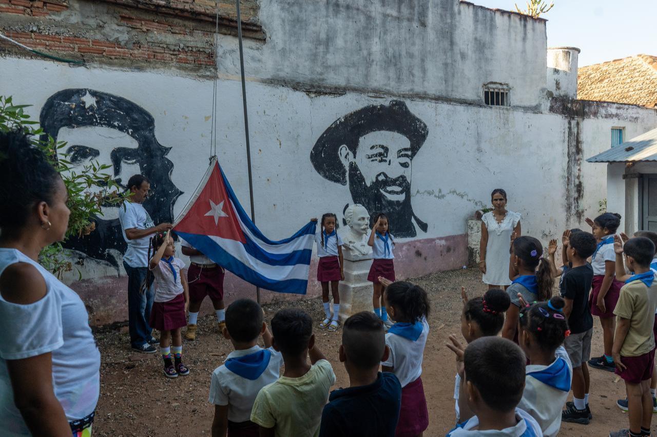 Children at a local school take part in a morning assembly, saluting the Communist Party during the raising of the Cuban flag in Trinidad, Cuba, May 8, 2026. (AA Photo)