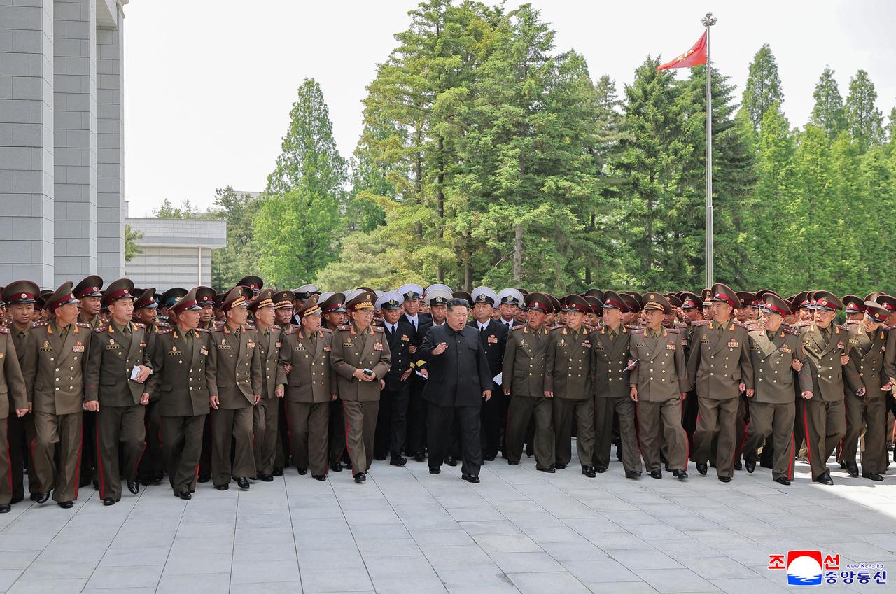 This picture taken on May 17, 2026 and released by North Korea's official Korean Central News Agency (KCNA) on May 18, 2026 shows North Korean leader Kim Jong Un (C) and commanders from all military divisions and brigades at the Party Central Committee headquarters in Pyongyang, North Korea. (AFP Photo)