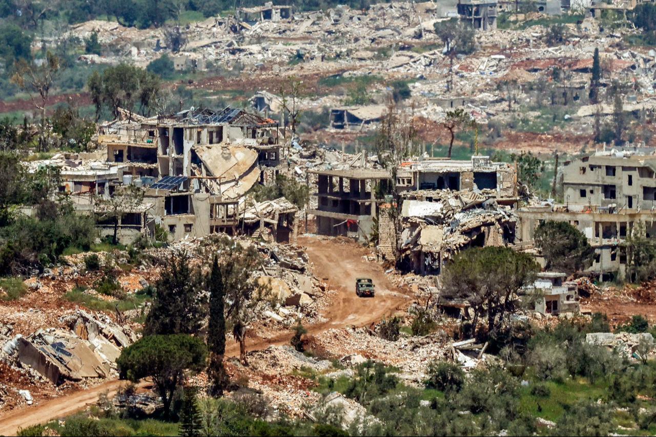 An Israeli military vehicle drives past houses destroyed in Israeli strikes in southern Lebanon as seen from a position across the border in the Upper Galilee in northern Israel, May 7, 2026. (AFP Photo)