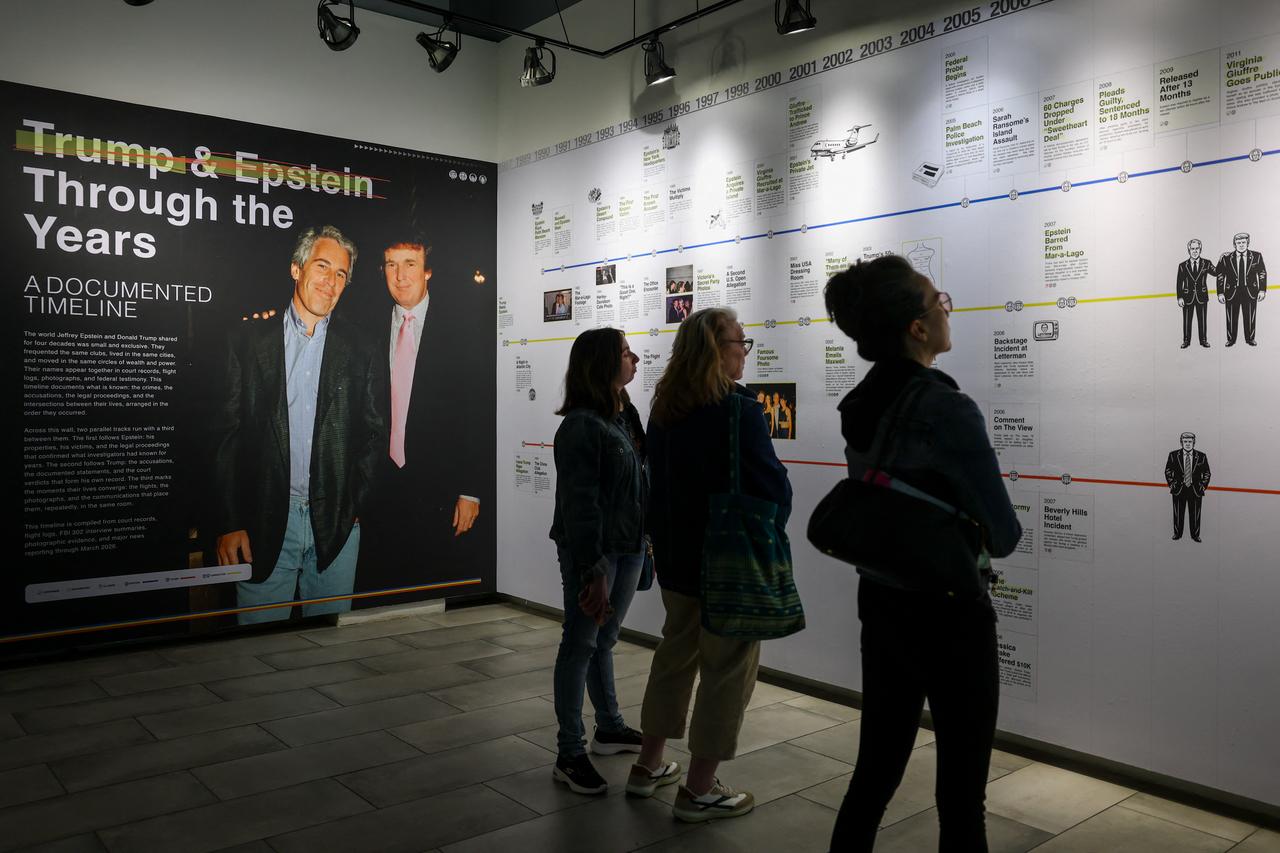 Visitors look at a timeline of events at the “Donald J. Trump and Jeffrey Epstein Memorial Reading Room”, a tribute to the survivors and victims of Epstein's crimes, where 3.5 million pages, 3,437 bound volumes of the Epstein files are displayed in New York City on May 11, 2026. (AFP Photo)