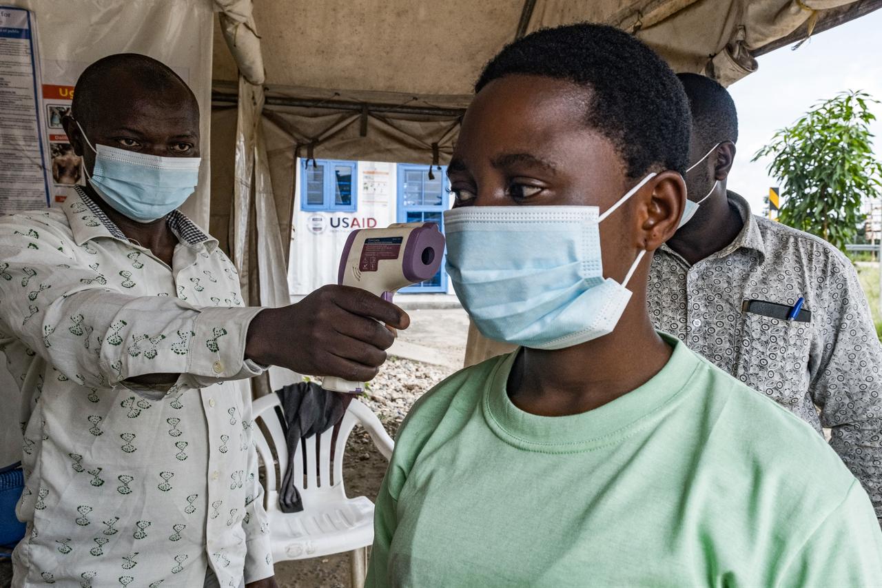 A border health officer checks a traveler’s temperature using a contactless infrared thermometer in Bundibugyo, Uganda on May 18, 2026. (AFP Photo)