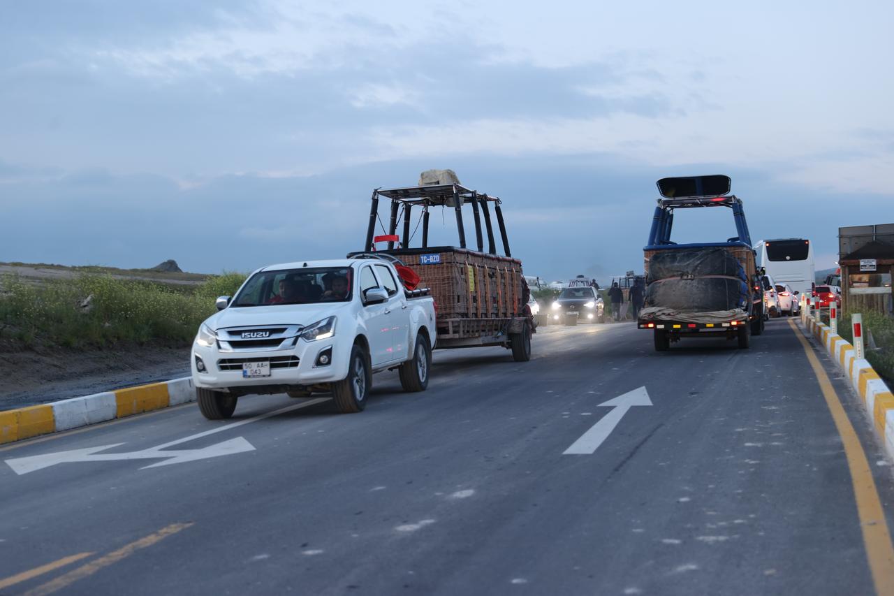 Vehicles towing hot air balloon baskets leave launch areas in Cappadocia after authorities cancelled flights due to unfavorable weather conditions in Nevsehir, Türkiye. (AA Photo)