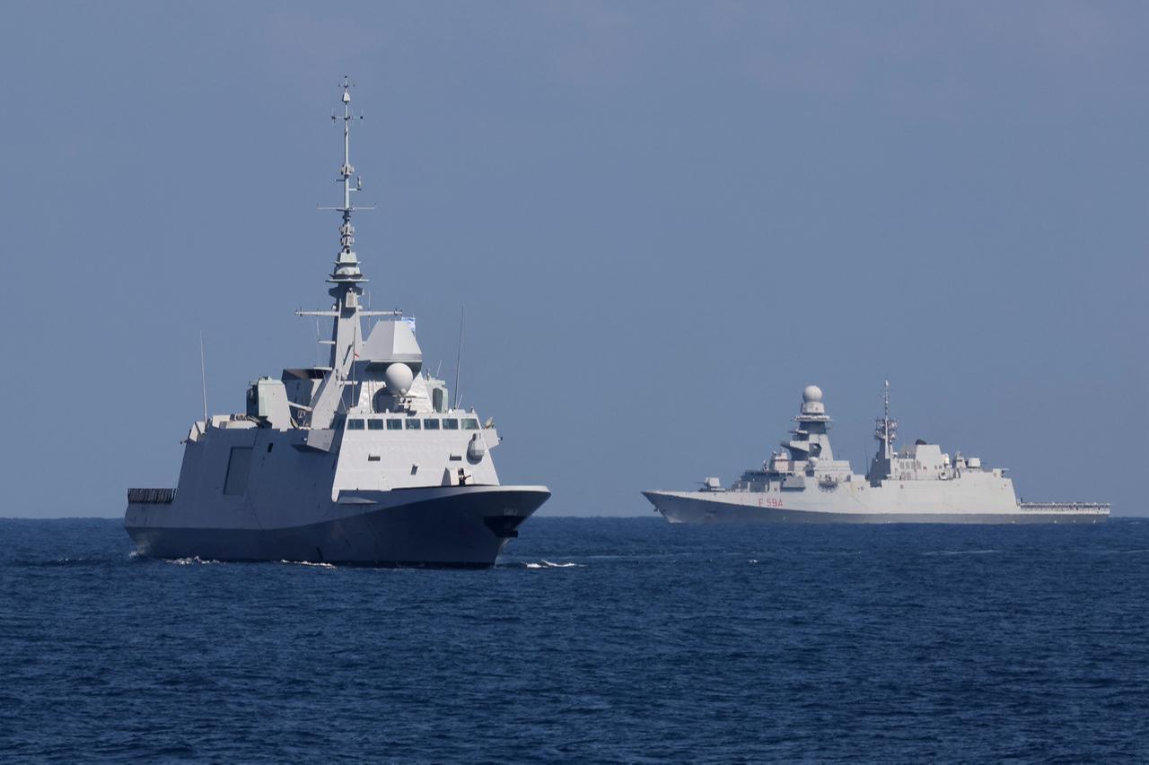The French Languedoc (D653), a FREMM multipurpose frigate, and Italian frigate Alpino (F594) (R) perform maneuvers during the "Noble Dina 23" multilateral aeronautical exercise in the Mediterranean Sea, March 27, 2023. (AFP Photo)
