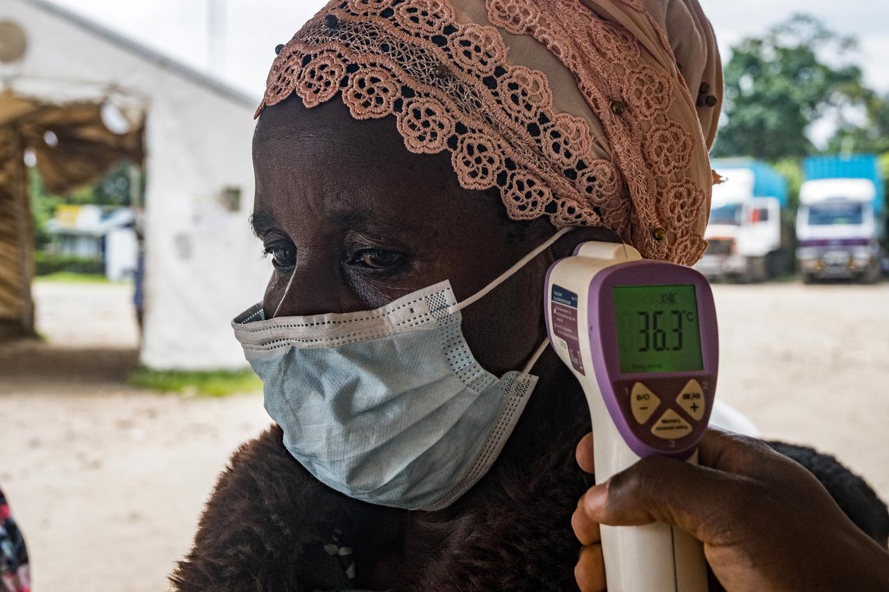 A border health officer at the Busunga crossing between Uganda and the Democratic Republic of Congo checks a traveler’s temperature in Bundibugyo, Uganda on May 18, 2026. (AFP Photo)