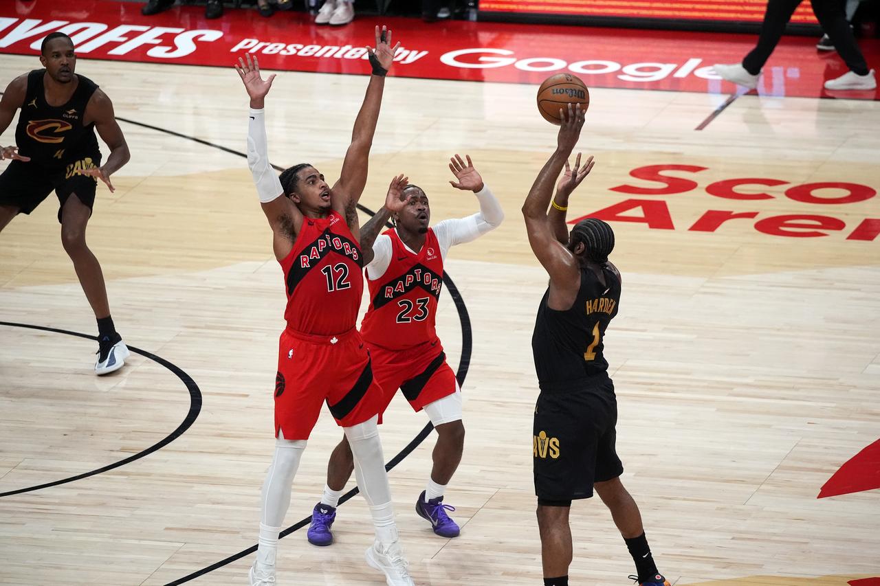 Colin Murray-Boyles (12) and Jamal Shead (23) of Toronto Raptors in action against James Harden (1) of Cleveland Cavaliers during the Game Six of the Eastern Conference First Round NBA Playoffs between Cleveland Cavaliers and Toronto Raptors at the Scotiabank Arena on May 1, 2026 in Toronto, Ontario, Canada. (AA Photo)