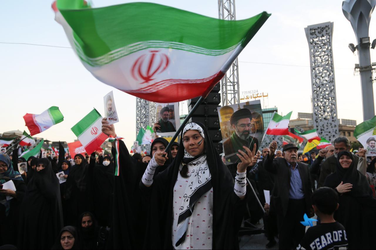 Iranians carry flags as they participate in a march pledging loyalty to new leader Mojtaba Khamenei in Tehran, Iran, April 29, 2026. (AA Photo)