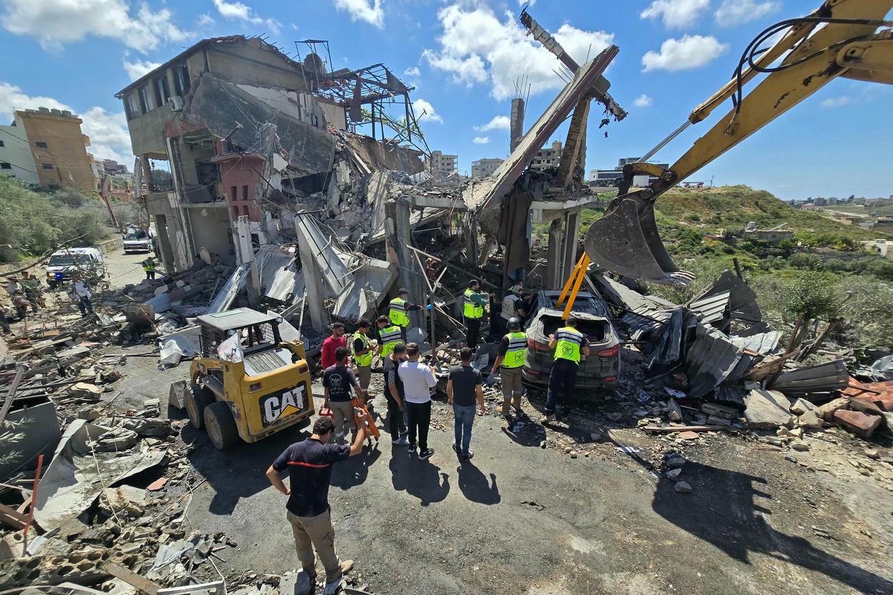 Workers tow a damaged car amongst the rubble at the site of an Israeli airstrike that targeted the southern Lebanese village of Ain Baal, May 1, 2026. (AFP Photo)