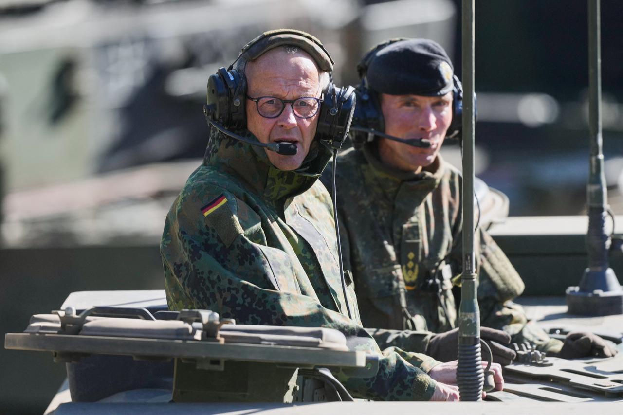 German Chancellor Friedrich Merz (L) and the Inspector of the Army Christian Freuding are sitting in a GTK Boxer tank at the German army barracks in Munster, northern Germany, April 30, 2026. (AFP Photo)
