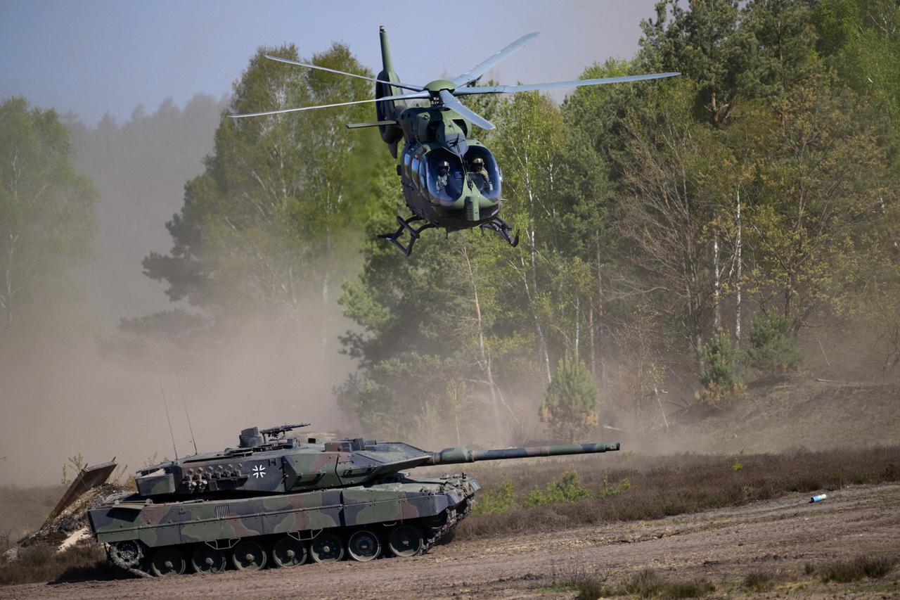 A Leopard 2A6 tank and an Airbus helicopter H145 of the German armed forces (Bundeswehr) are seen during a demonstration for the German Chancellor visiting the troops at the German armed forces' barracks in Munster, northern Germany, April 30, 2026. (AFP Photo)