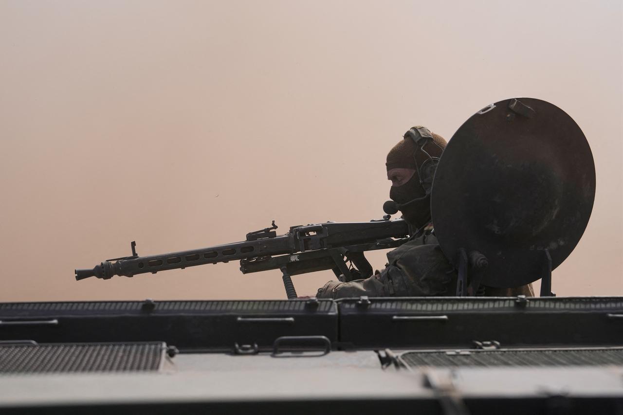 A commander sits in a battle vehicle Fuchs in the dust during a visit of German Chancellor Friedrich Merz to the army at the base in Munster, northern Germany, on April 30, 2026, as they visit the troops of the German Army. (AFP Photo)