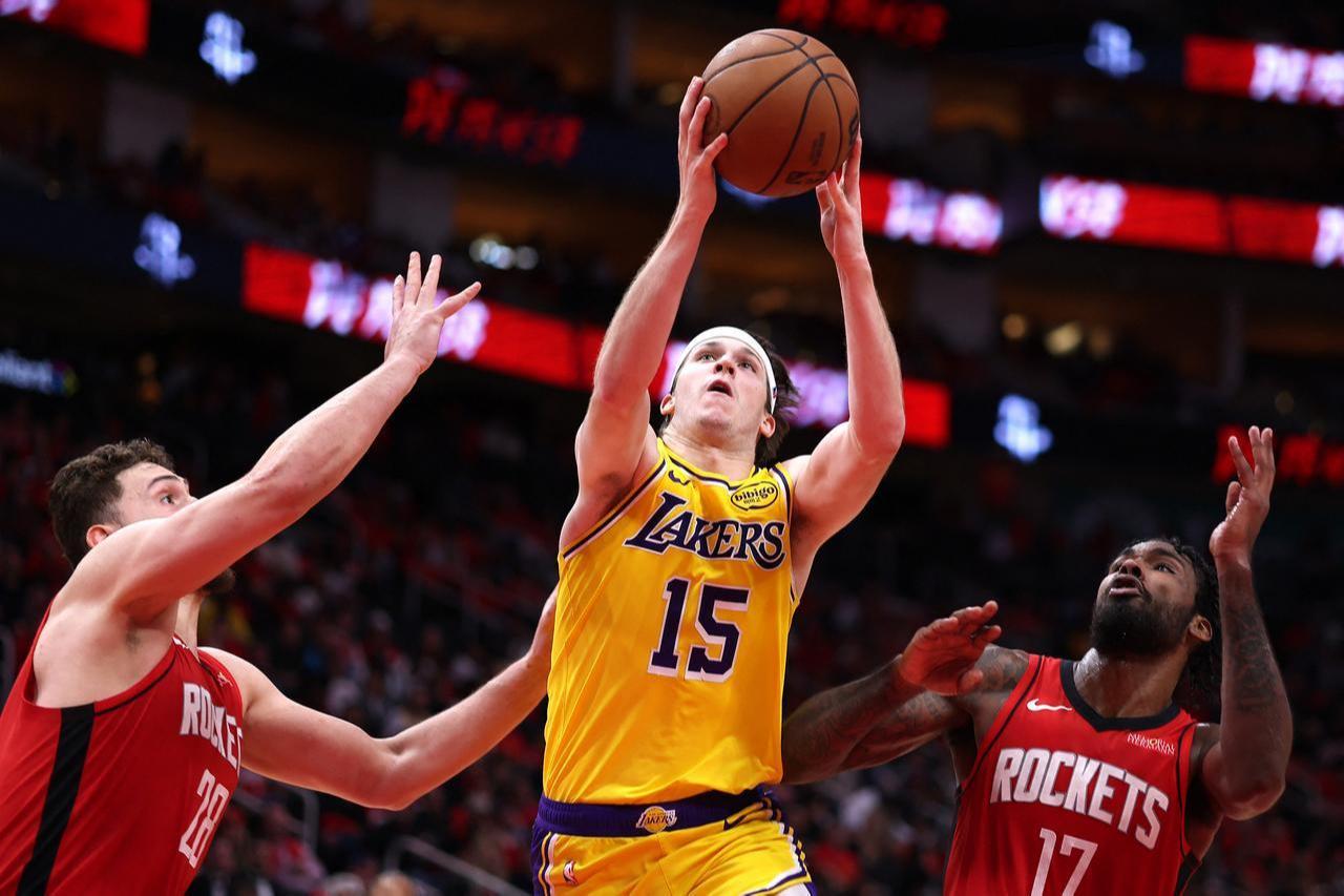 Austin Reaves #15 of the Los Angeles Lakers drives to the basket against Alperen Sengun #28 and Tari Eason #17 of the Houston Rockets during the third quarter in Game Six of the First Round of the NBA Western Conference Playoffs at Toyota Center, in Houston, Texas, May 01, 2026. (AFP Photo)