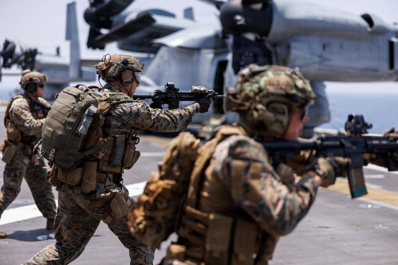 U.S. Marines fire rifles during a deck shoot aboard the forward-deployed amphibious assault ship USS Tripoli (LHA 7) during Operation Epic Fury, April 2, 2026. (Photo via U.S. Marine Corps)