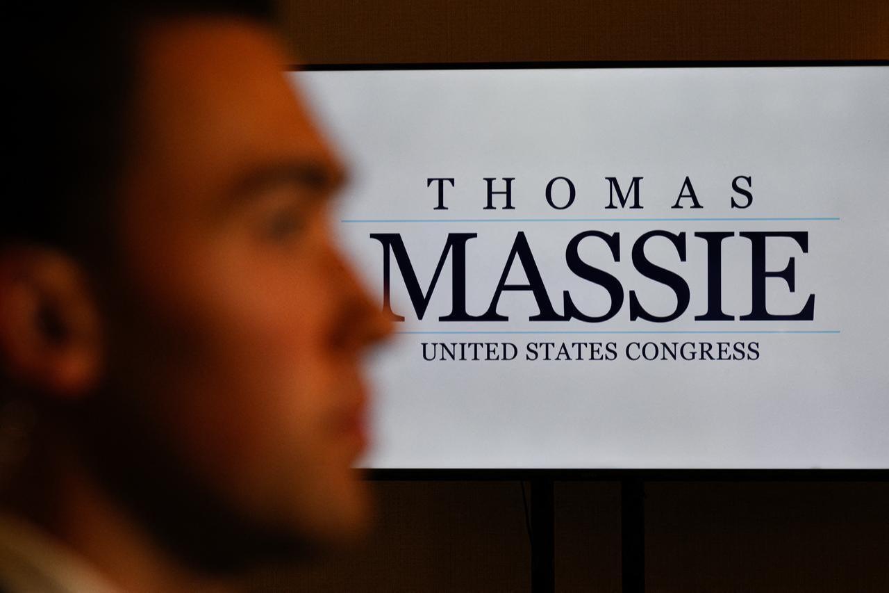 A Thomas Massie campaign screen is seen as an on-air reporter looks on at a primary election night event for U.S. Rep. Thomas Massie (R-KY) in Hebron, Kentucky on May 19, 2026. (AFP Photo)