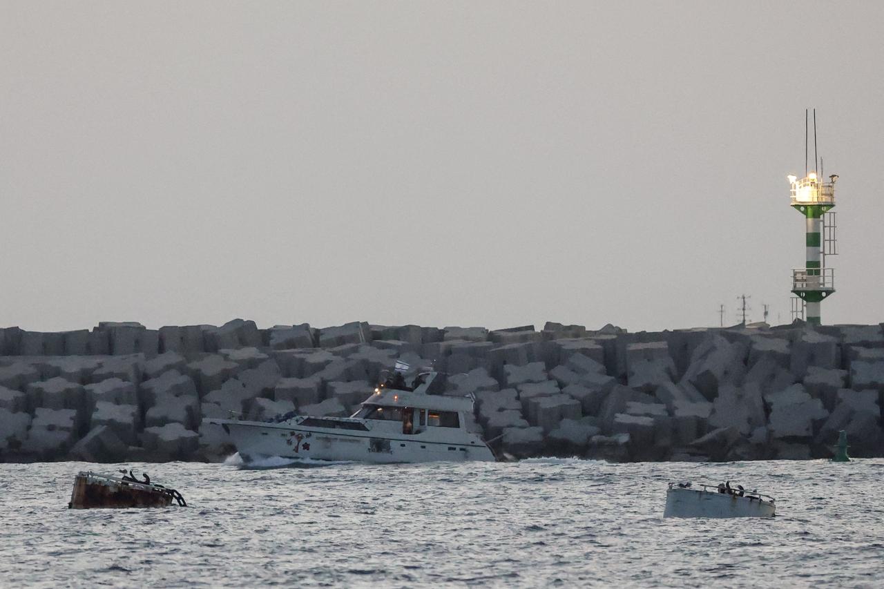A boat bearing symbols of one of the vessels belonging to the Gaza-bound aid flotilla (L) and intercepted by the Israeli navy, is motored towards the Israeli port of Ashdod, about 40 kilometres south of Tel Aviv, Israel, May 19, 2026. (AFP Photo)