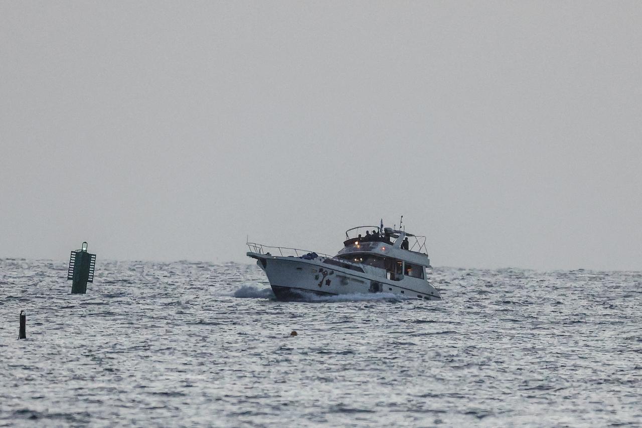 A boat bearing symbols of one of the vessels belonging to the Gaza-bound aid flotilla (L), intercepted by the Israeli navy, is motored towards the Israeli port of Ashdod, about 40 kilometres south of Tel Aviv, Israel, May 19, 2026. (AFP Photo)