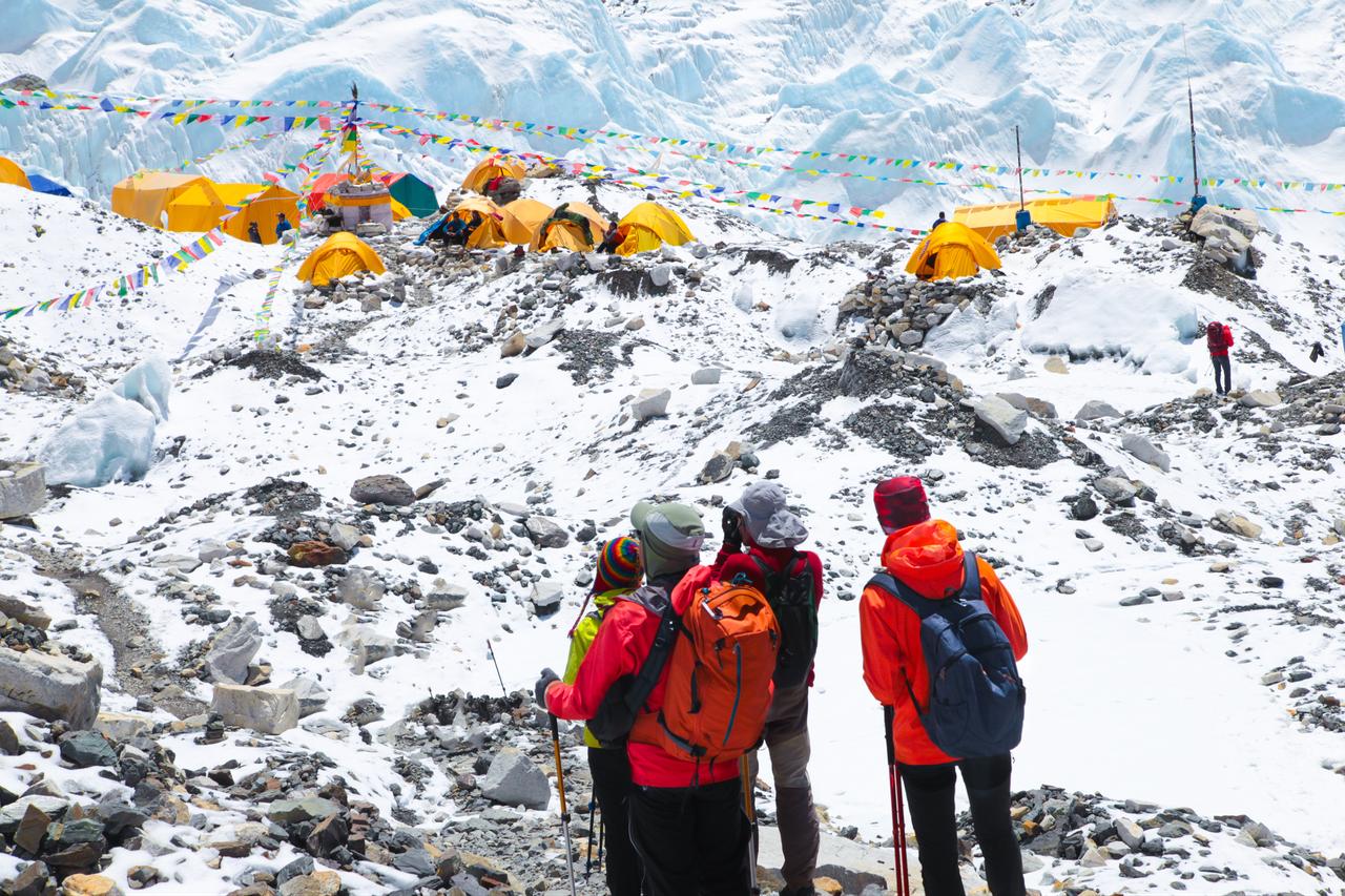 Hikers enjoying the magnificent view of Mount Everest base camp, in the Himalayas, Nepal. (Photo via Envato)