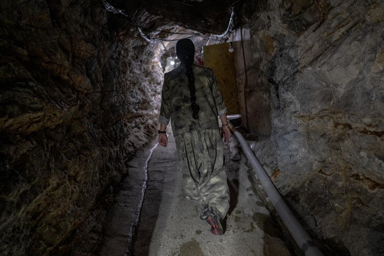 Terrorist organization PJAK members walk inside a tunnel at a site near the Iraqi border with Iran in Iraq, March 8, 2026. (AFP Photo)