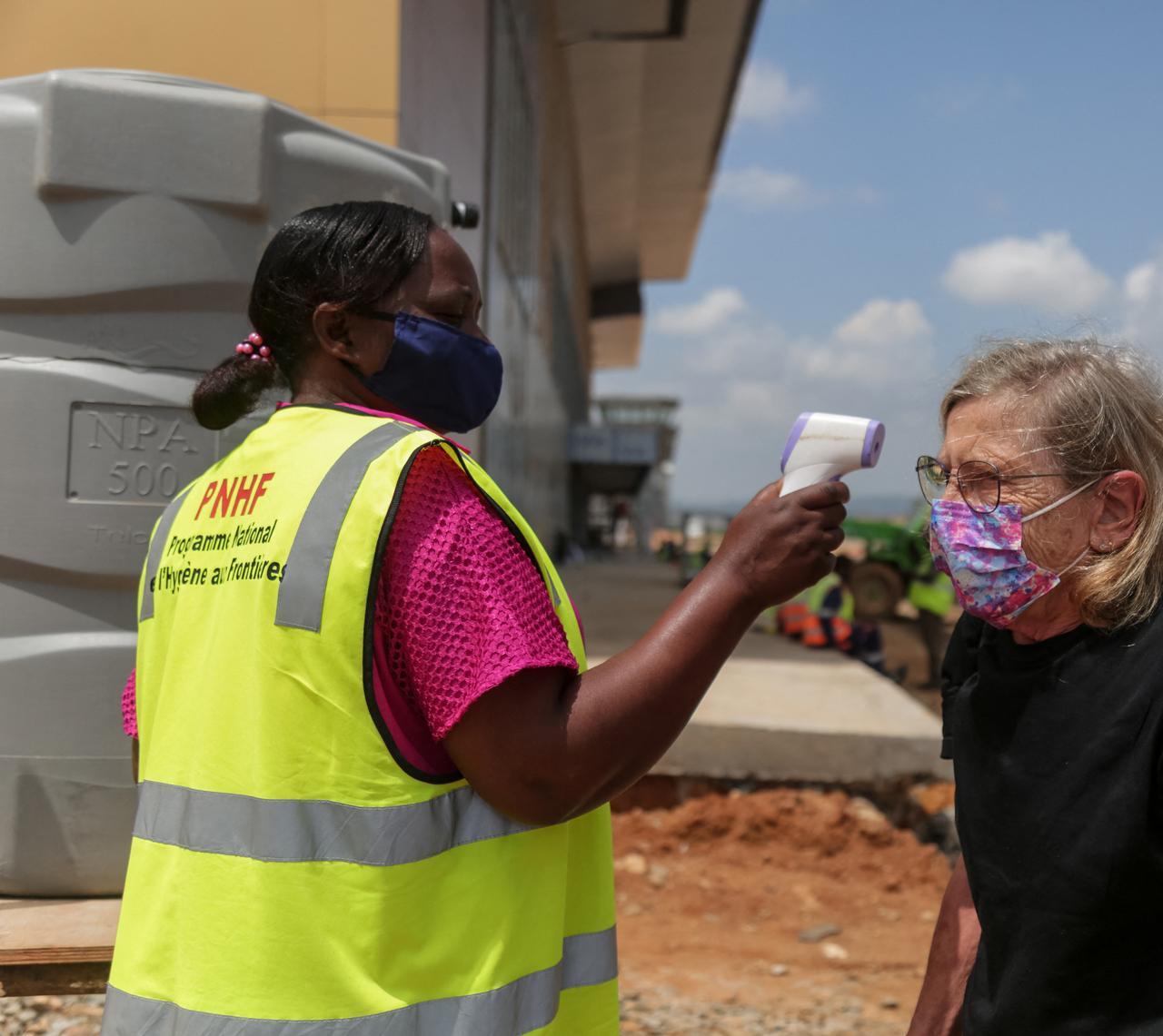 A border health officer measures a passenger's temperature at the Bunia airport in Bunia on May 21, 2026. (AFP Photo)